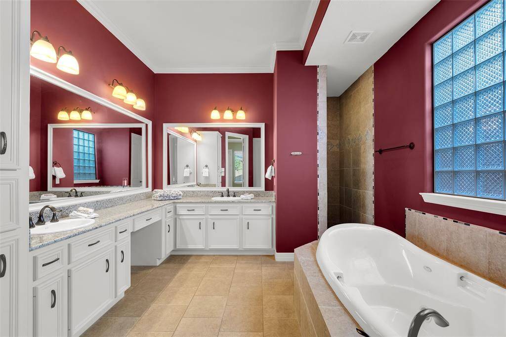 Luxurious en suite bathroom with a dream of a soaking tub and walk in shower behind tub.