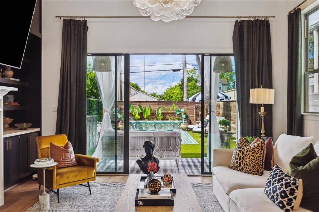 Large sliding glass doors open to outdoor space, allowing for plenty of natural light and seamless indoor-outdoor living.