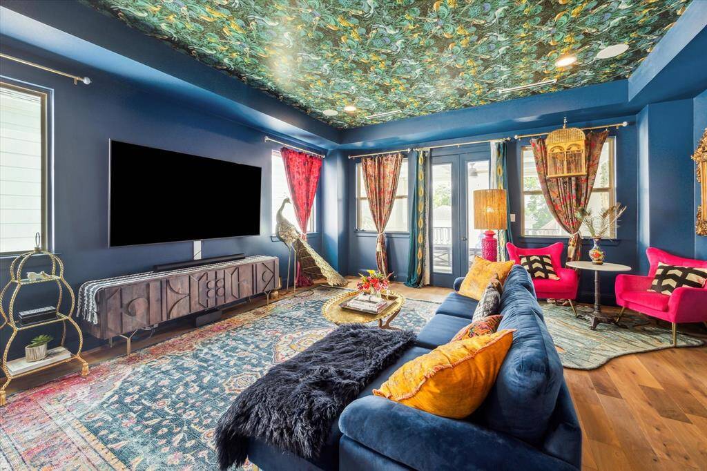 Vibrant game room or additional family room with access to the massive covered terrace. Ample natural light streams through multiple windows