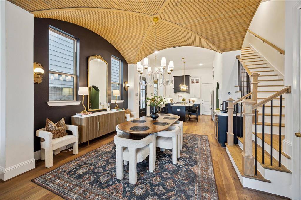 Open plan dining area with a stunning ceiling and elegant light fixtures