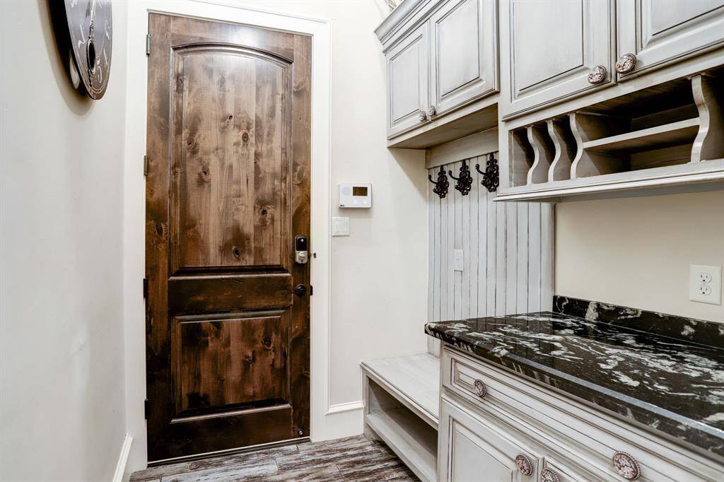 Mudroom with entry to the 4 car garage.