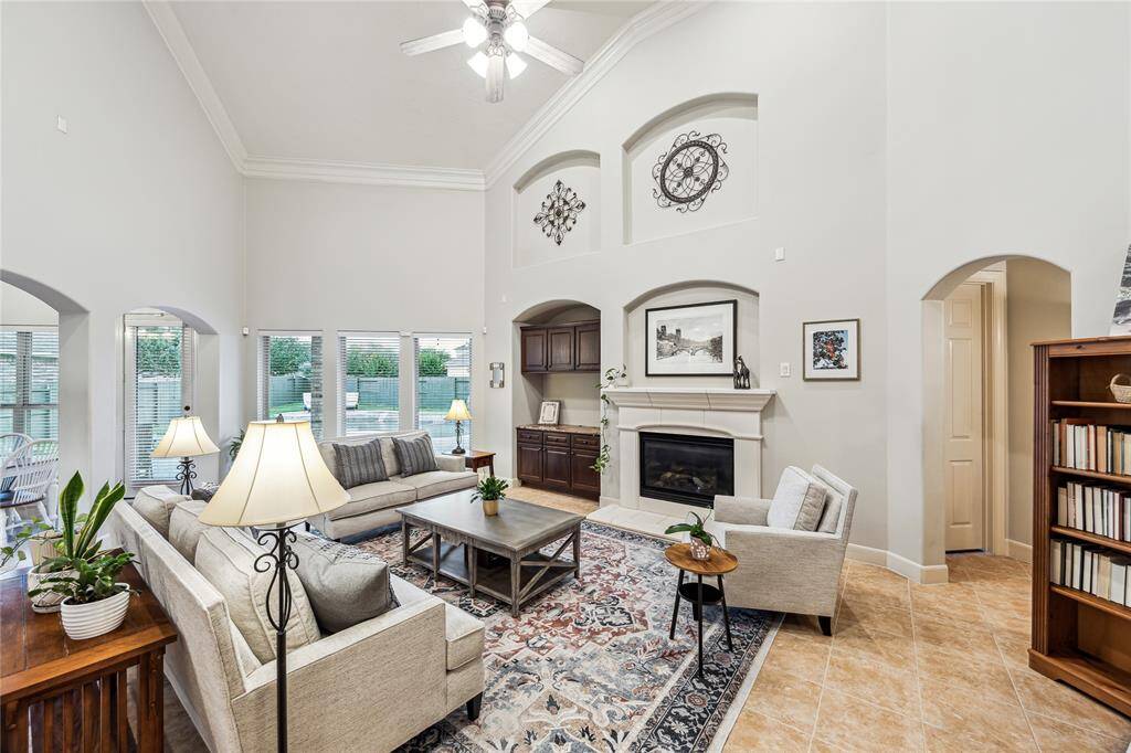 Warm and inviting family room featuring a stone-surround fireplace.