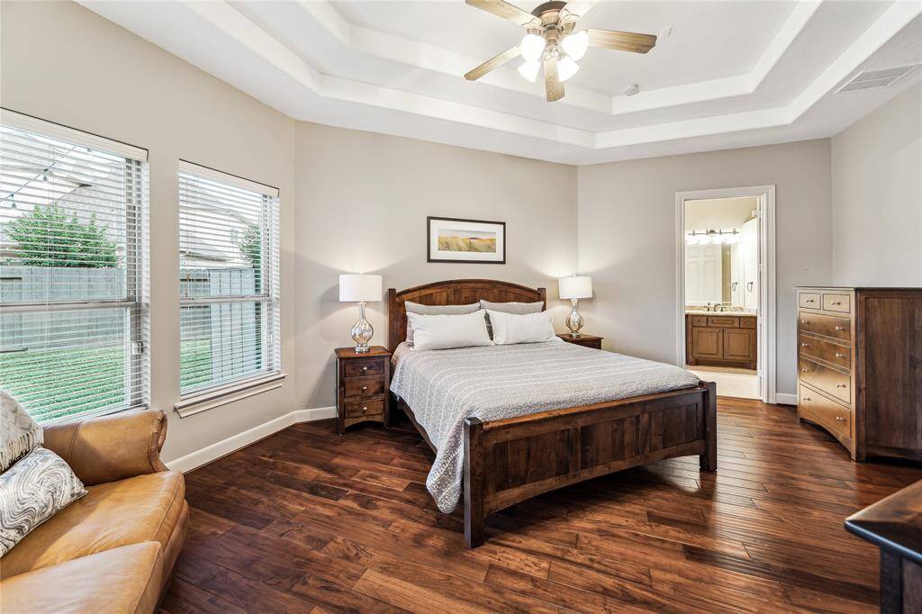 Spacious primary bedroom with abundant natural light, offering a serene retreat with generous room to unwind.