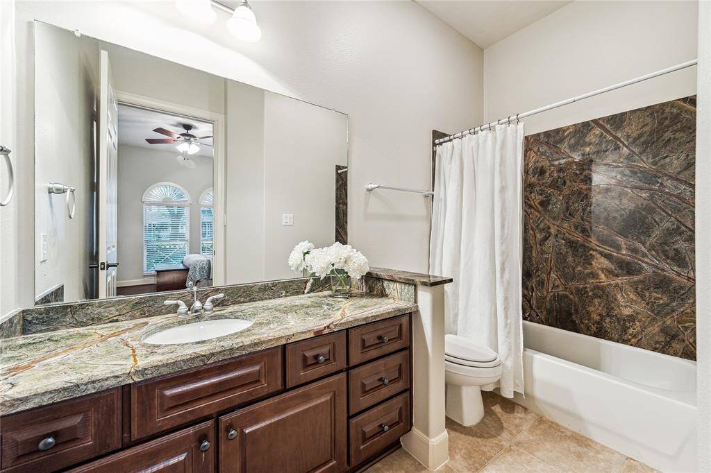 Updated en suite bathroom for the secondary bedroom, featuring beautiful stone finishes.