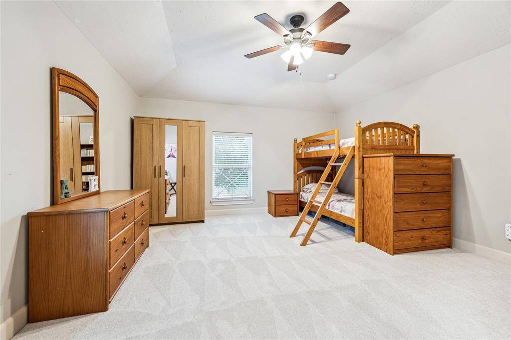 Spacious secondary bedroom upstairs, offering plenty of natural light and ample closet space.