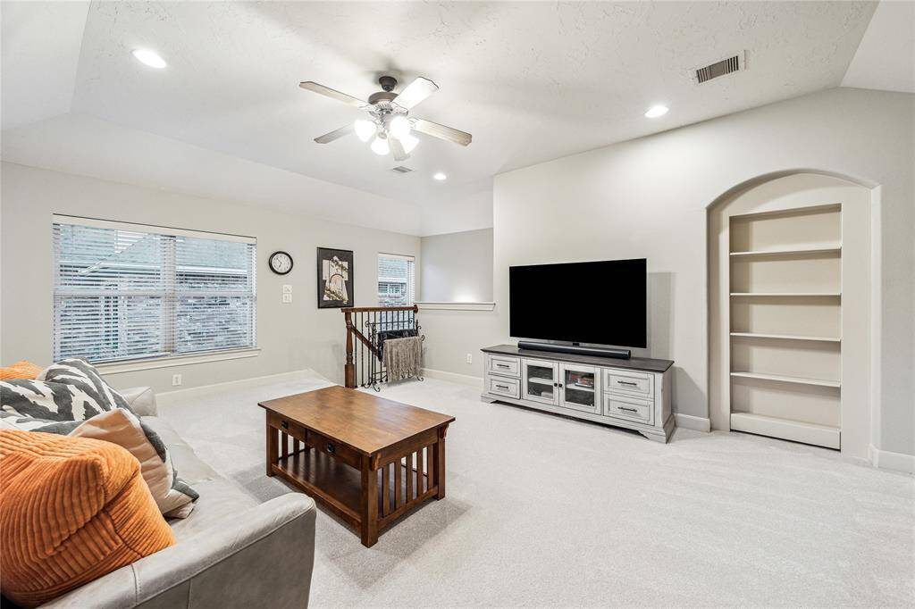 Charming built-in bookcase marks the entrance to the versatile 6th bedroom or flex room—perfect for use as a private retreat, home office, or bedroom.