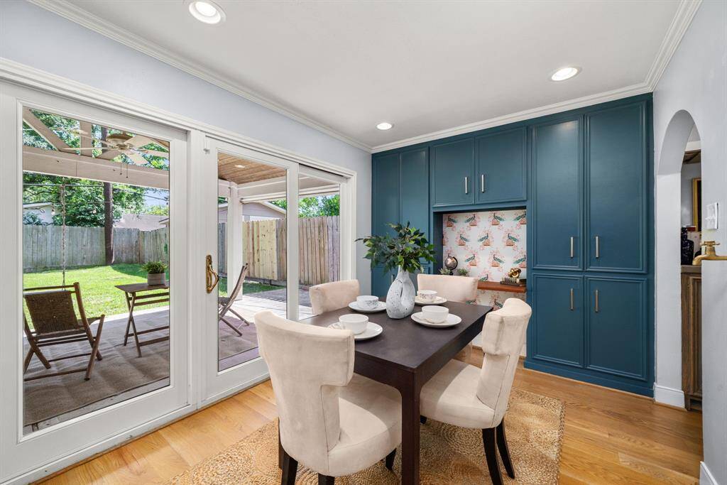 Start your mornings in this sunny breakfast nook with custom built-ins and easy patio access.