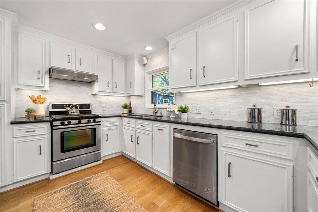 Sleek, functional & freshly updated, this kitchen features granite counters, stainless steel appliances, and plenty of storage for effortless cooking and entertaining.