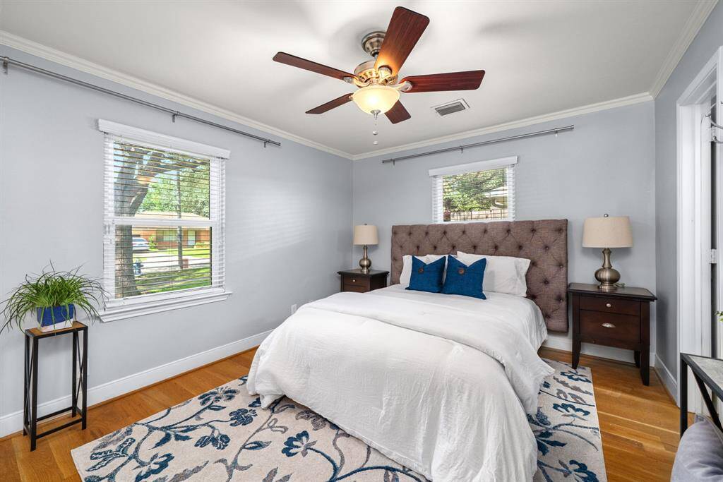 Your private retreat awaits—this spacious primary bedroom offers natural light, hardwood floors & a calming atmosphere. The perfect place to unwind.