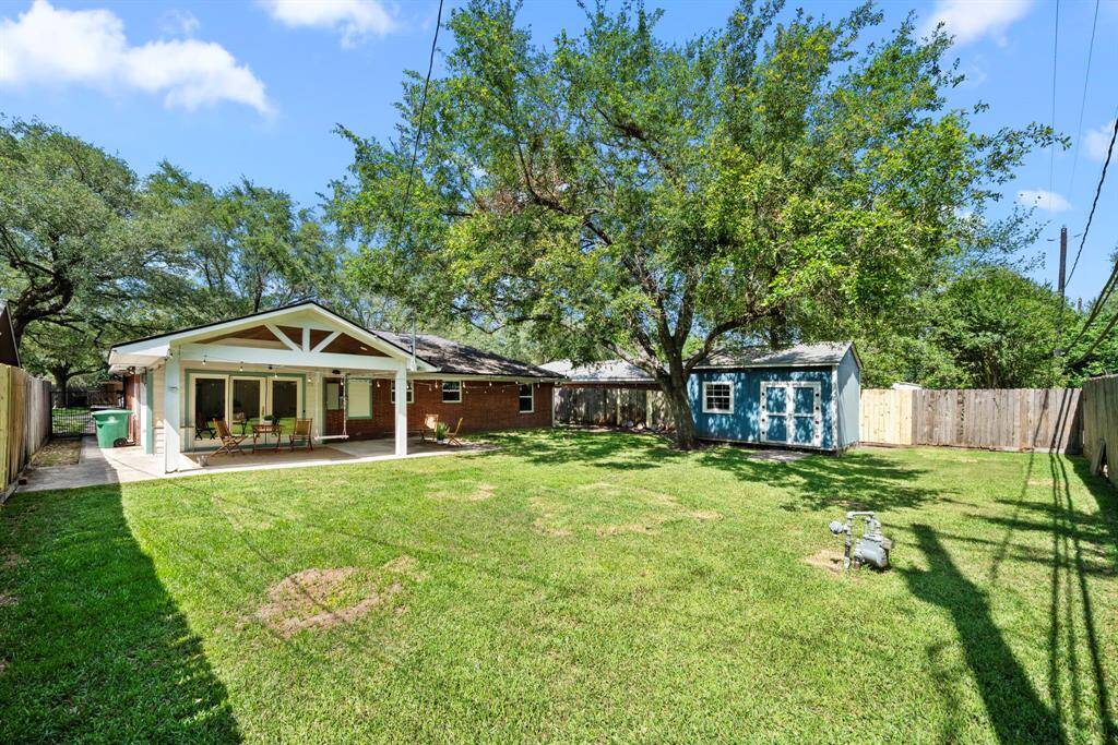 Expansive backyard with mature trees, large storage shed & a spacious covered patio—plenty of room to relax, play & entertain. A must-see outdoor space!