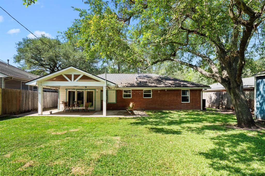 Spacious backyard with mature trees & a covered patio—ideal for gatherings, playtime, or simply relaxing outdoors. A must-see space with endless potential!
