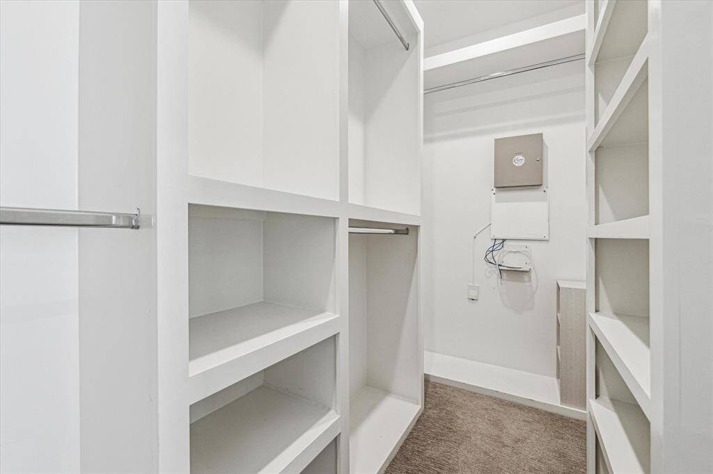 The walk-in primary closet is tucked away in the bathroom. Nice built-ins!