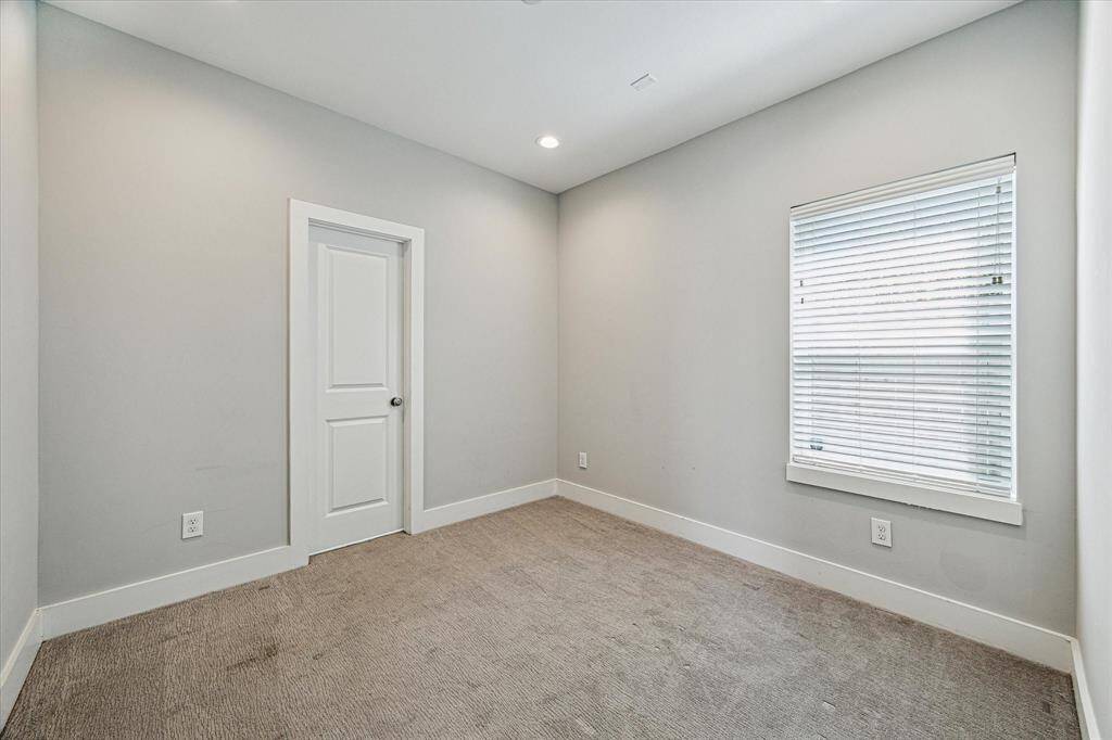 The first floor secondary bedroom features an en-suite bathroom and closet. Also perfect for an office!