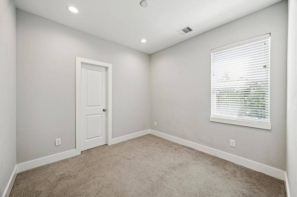 The secondary bedroom on the third floor features an en-suite bathroom and closet.