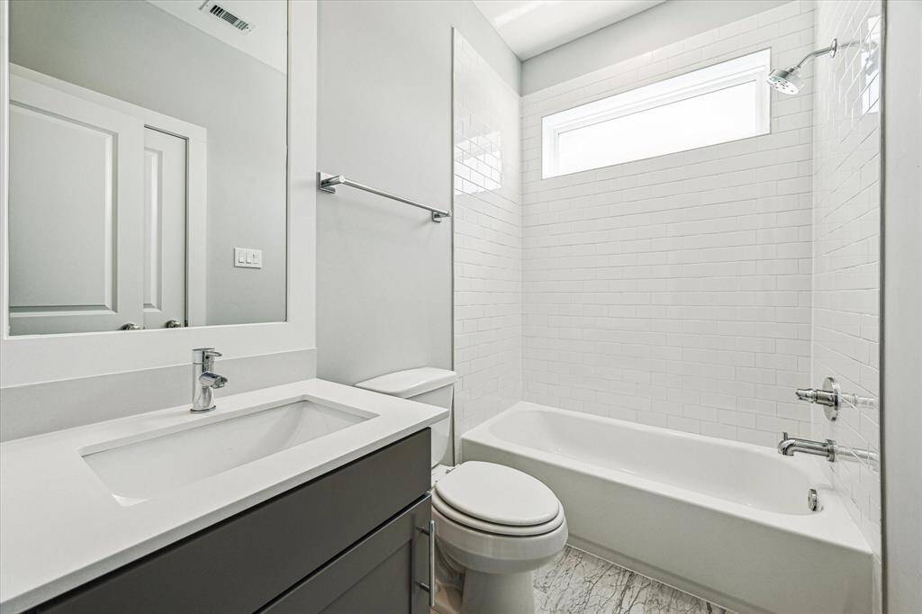 The en-suite third floor bathroom features stylish tile flooring, shower/tub combo, and closet.