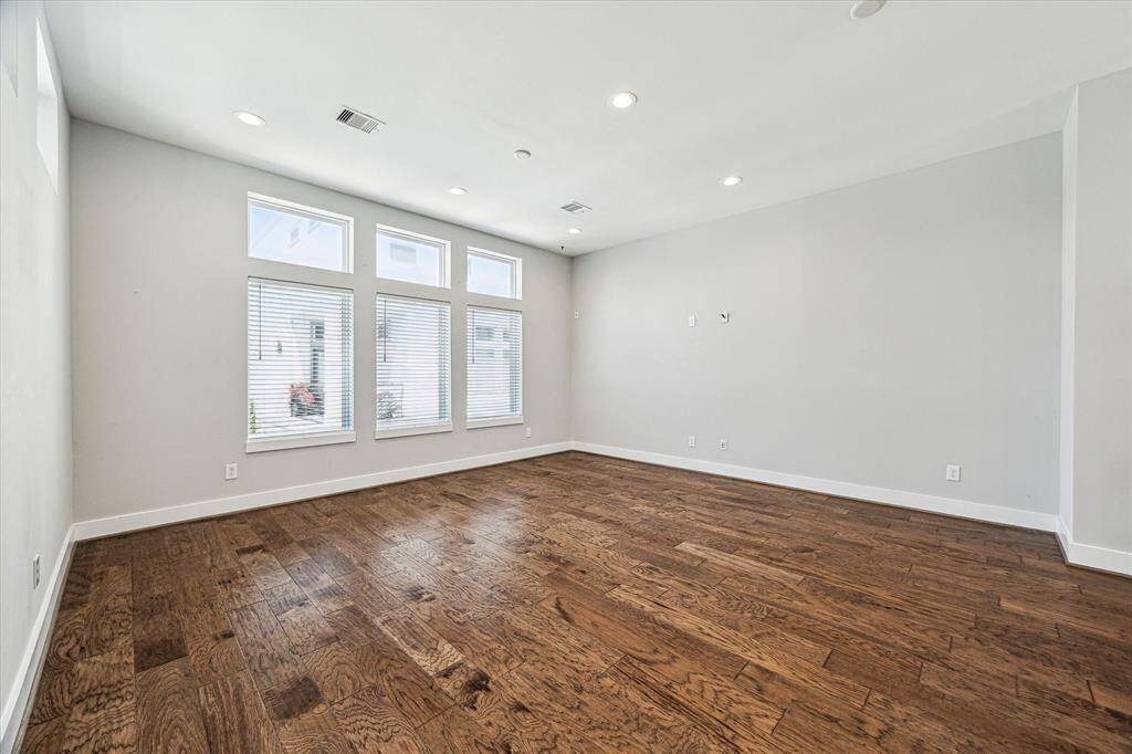 The second floor boasts a spacious living room with windows bringing in tons of natural light. Hardwoods throughout the living spaces.