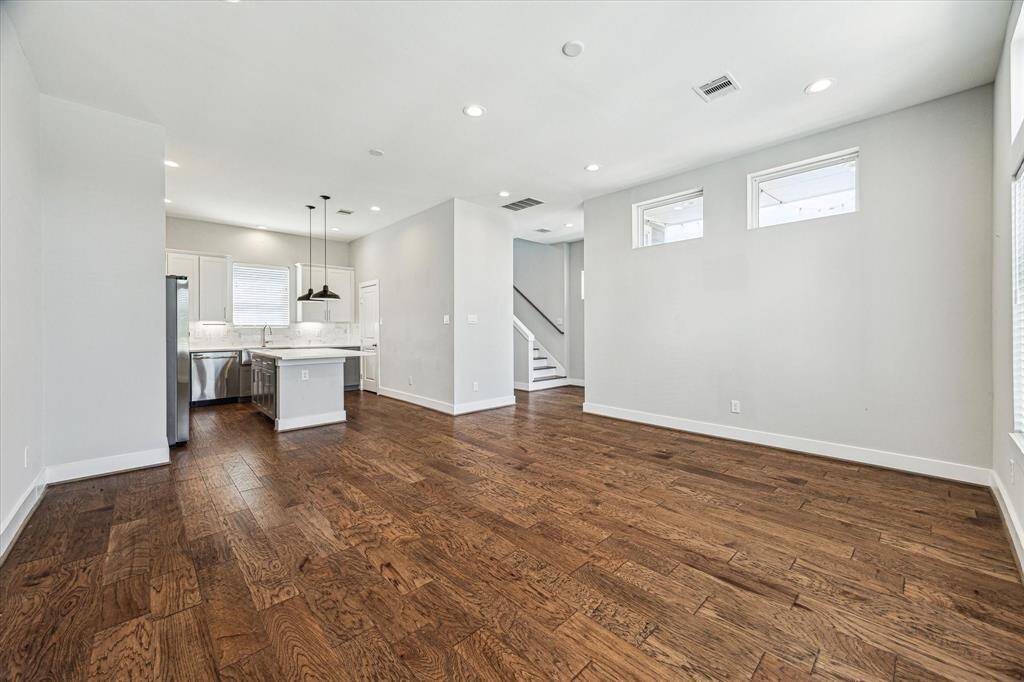 The living room flows seamlessly into the kitchen. A half bath is conveniently located on the other side of the wall.