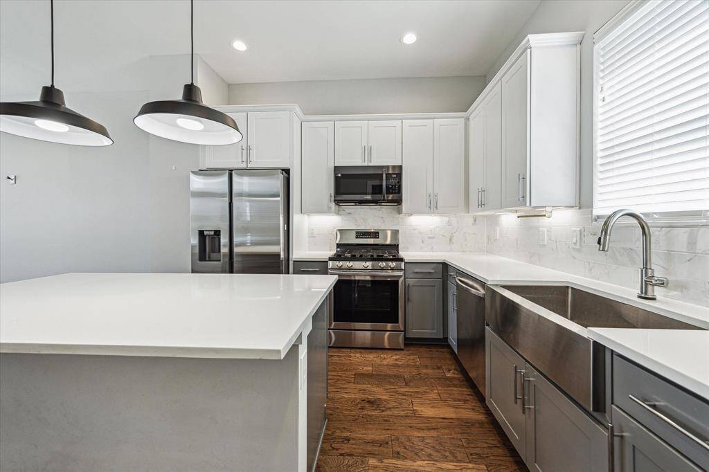 Samsung stainless steel appliances, an oversized farm sink, and under cabinet lighting. This kitchen will make cooking easy.