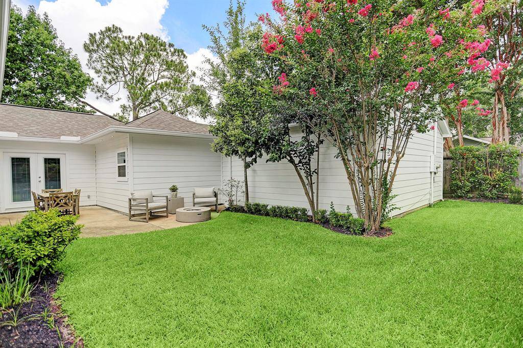 This photo highlights the crepe myrtle in full bloom, adding vibrant color and charm to the property's landscape