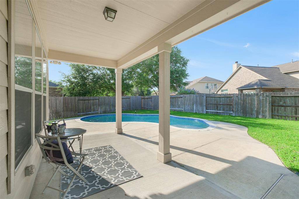 This large, covered back patio is ready for your outdoor entertaining!