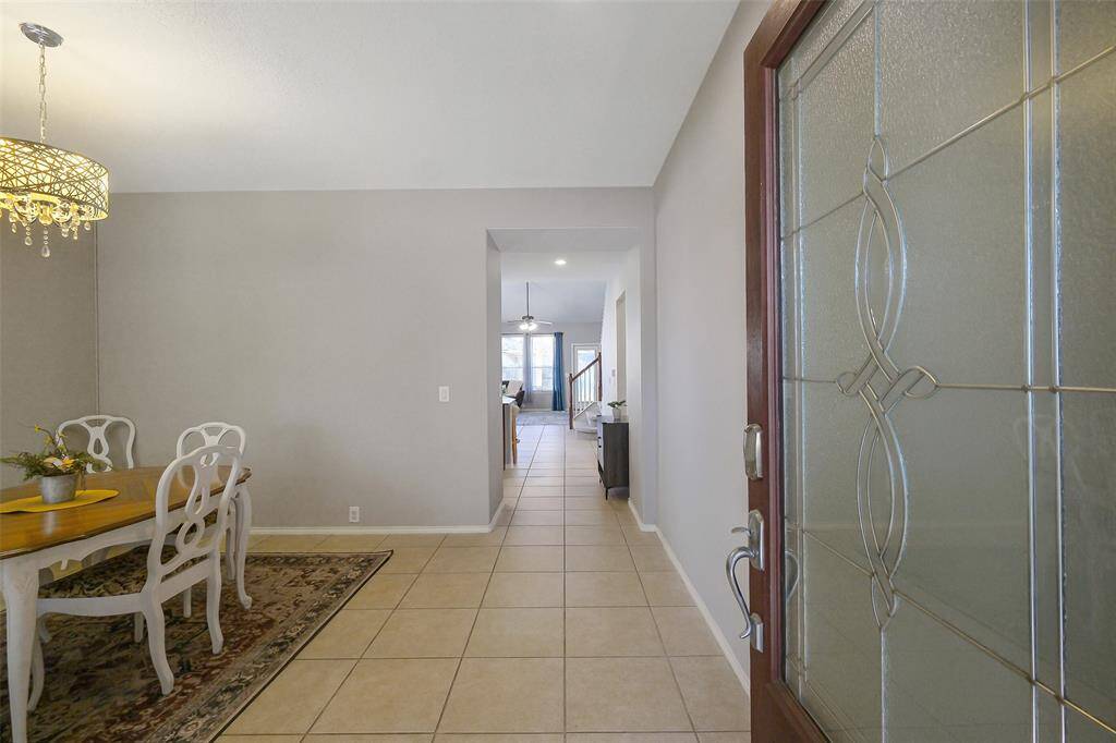 The front door opens into the foyer and formal dining room.