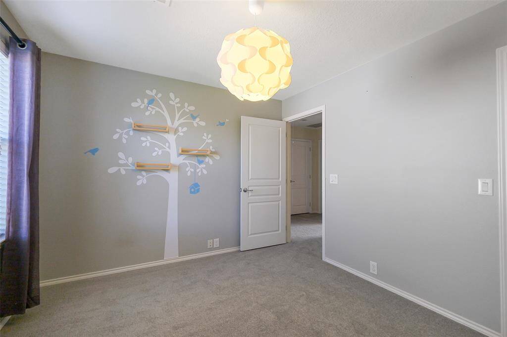 Guest bedroom number two with custom light fixture