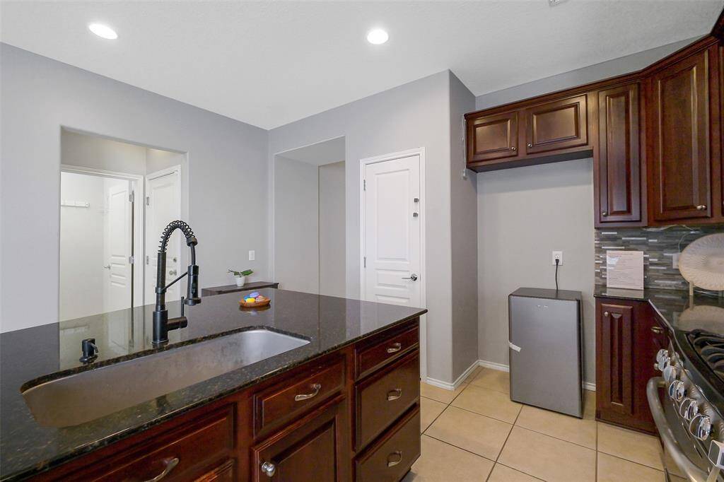 Kitchen sink is located on the island with upgraded faucet and soap dispenser.