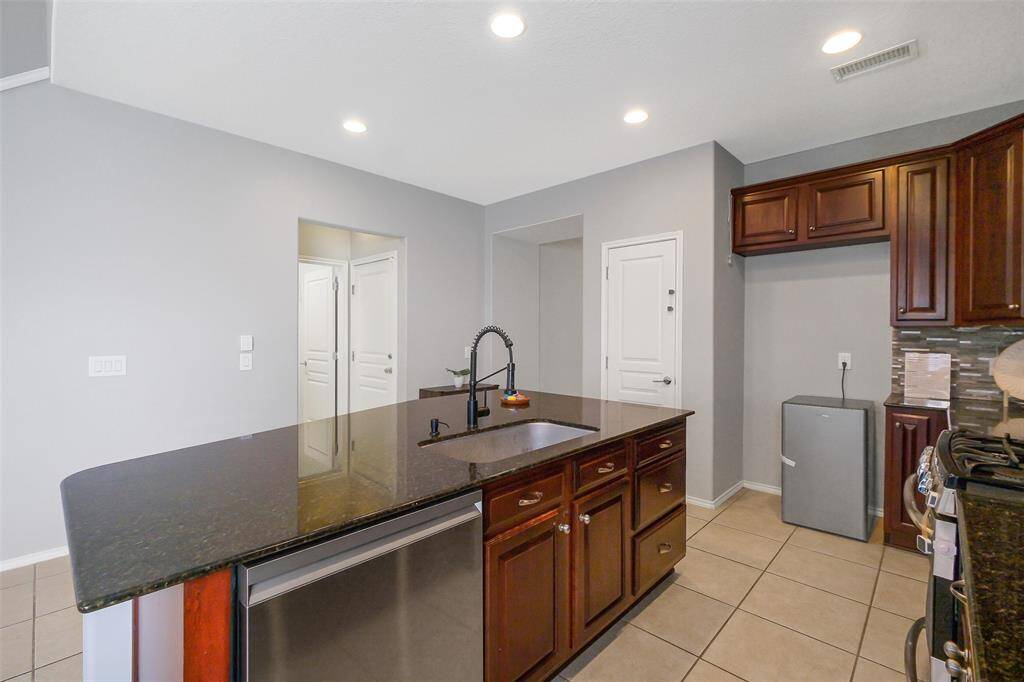 Kitchen island and stainless steel dishwasher.