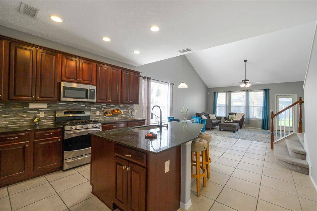The beautiful kitchen is open to the breakfast area and living room. The large island offers counter height bar seating.