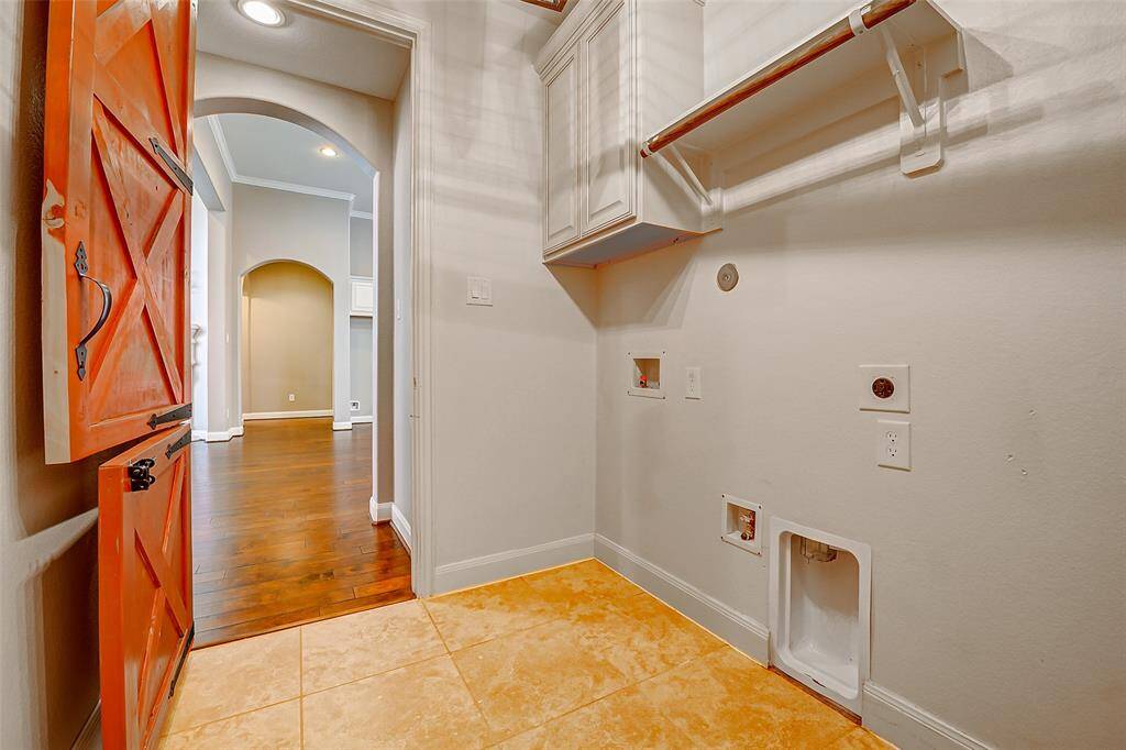 View from the utility room into the hallway. The original white door can be rehung, if the new owner prefers it to the red custom door.
