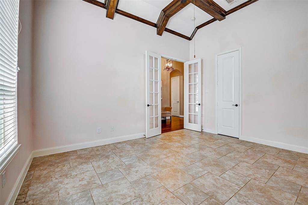 The home office is located to the right of the front door and has French doors opening to the entry hallway.
