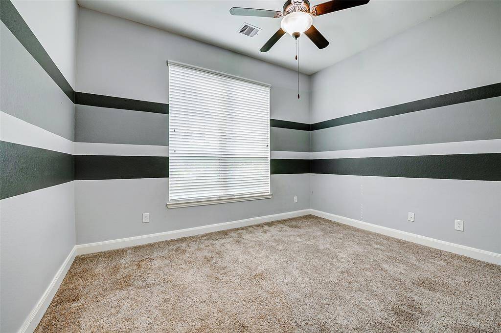 This bedroom is located at the front of the house, to the left of the front door.