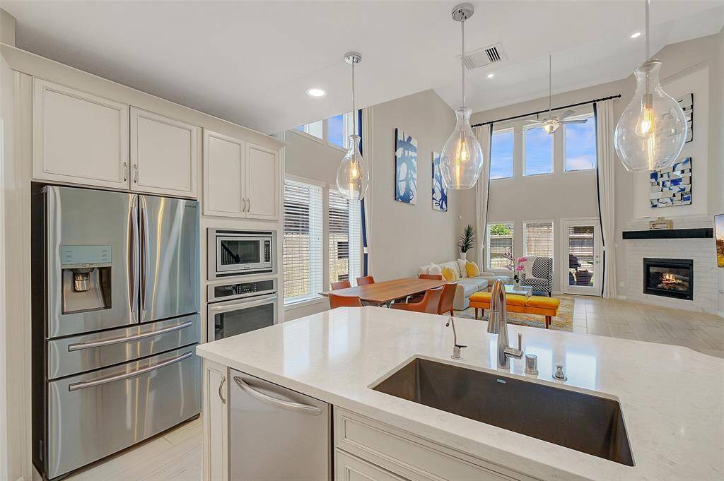 Kitchen is equipped with stainless steel appliances & open to family room.
