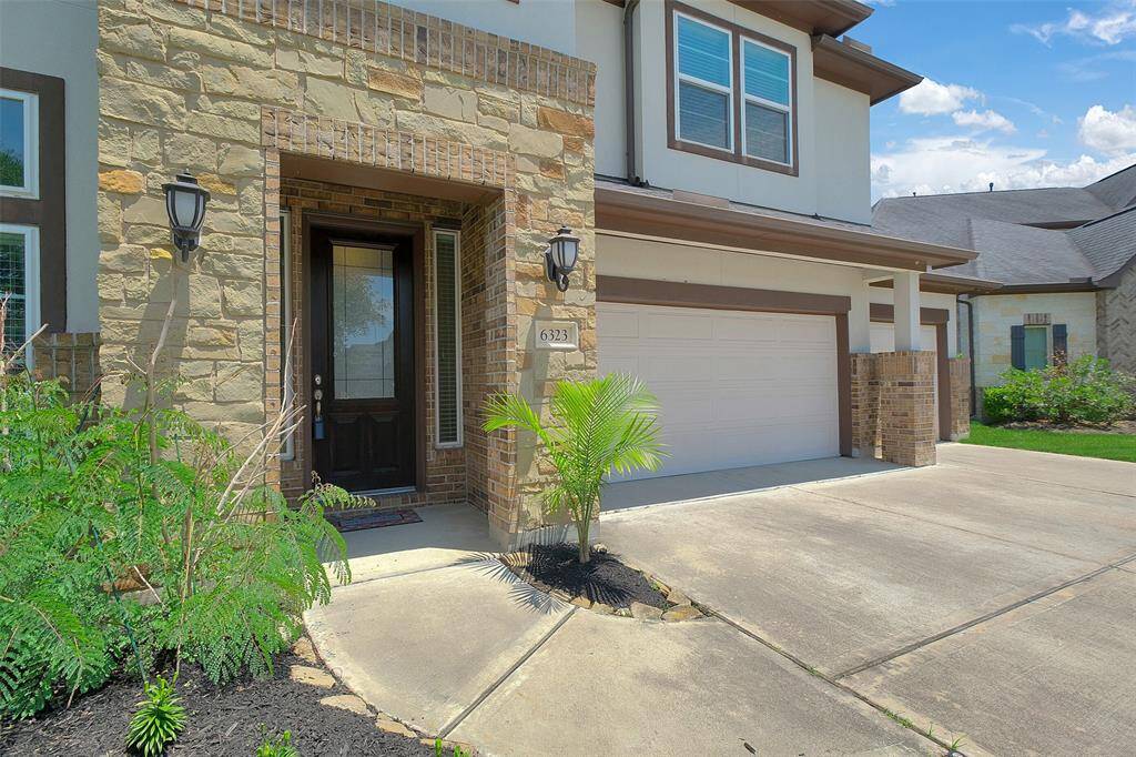 Beautiful curb appeal exterior with combination of stucco, stone and bricks.
