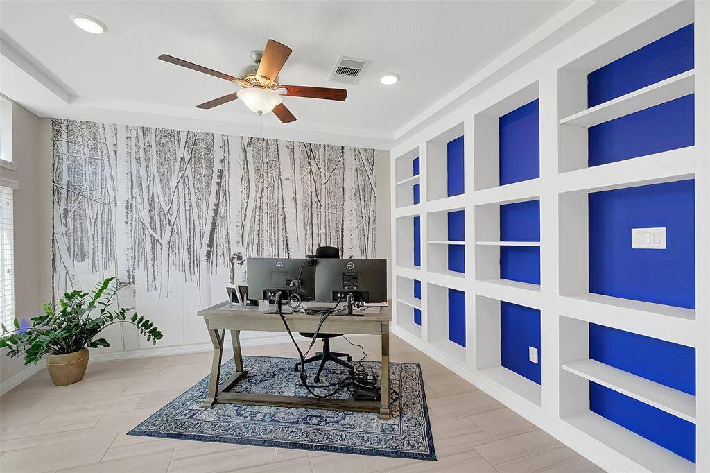 Custom built shelving in the study/or dining room welcome you.