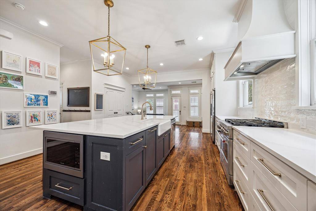 The island is large enough to fit 6 people comfortably, making it a nice spot for casual meals or gathering while cooking.  The island offers an abundance of storage space as well as a built-in microwave.