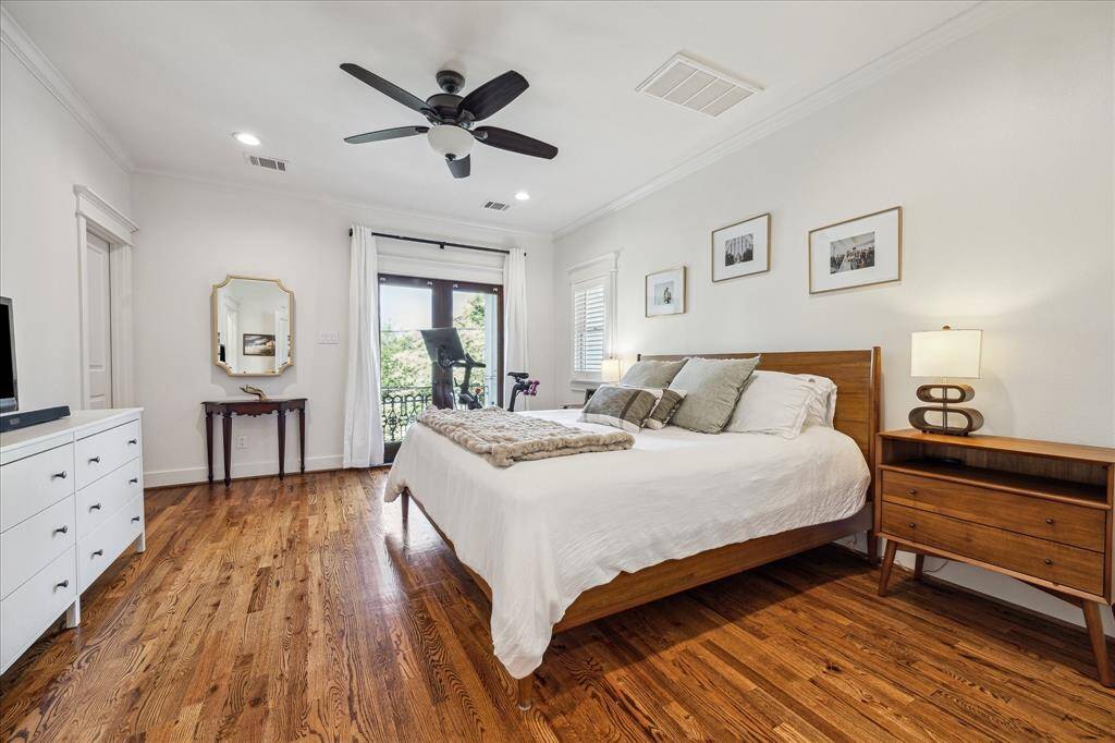 Light and bright primary suite with direct access to a large balcony overlooking the front yard; The primary bedroom features a large walk-in closet.