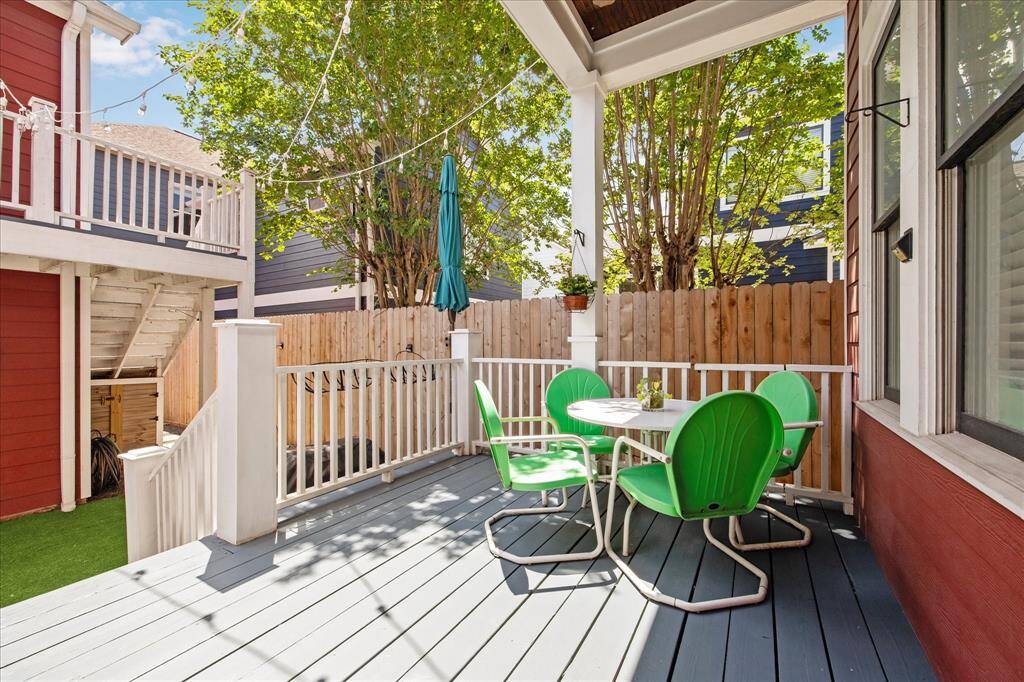 Large covered deck with stair access to the backyard