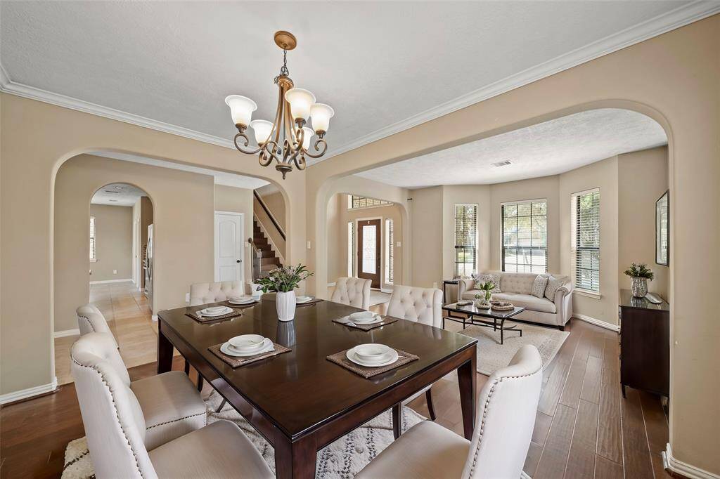 Dedicated Dining Room with handsome hardwood floors, crown molding, charming chandelier and space to eat meals together or entertain guests