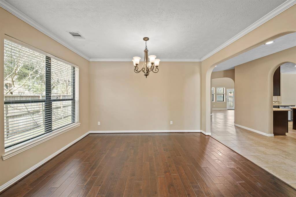 View of the Dedicated Dining Room with natural lighting from windows, chandelier and easy kitchen access