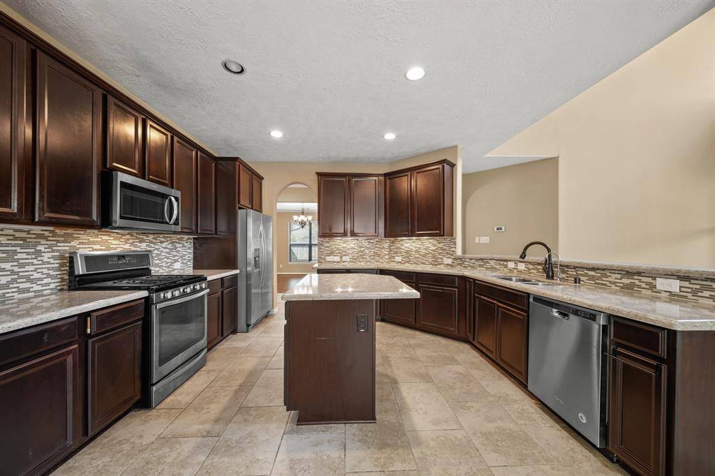 Gourmet Kitchen boasts granite countertops, island for extra cooking space and a Breakfast Bar for additional seating
