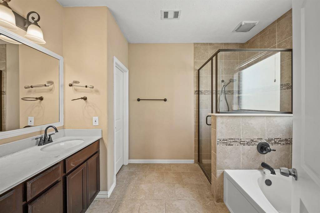 Another view of the Primary Bathroom with large garden tub, shower and space for getting ready in the mornings