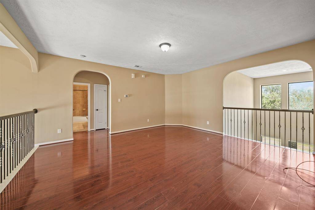 Gigantic Game Room on the second level with wood flooring and an abundance of space for time together enjoying games or movies