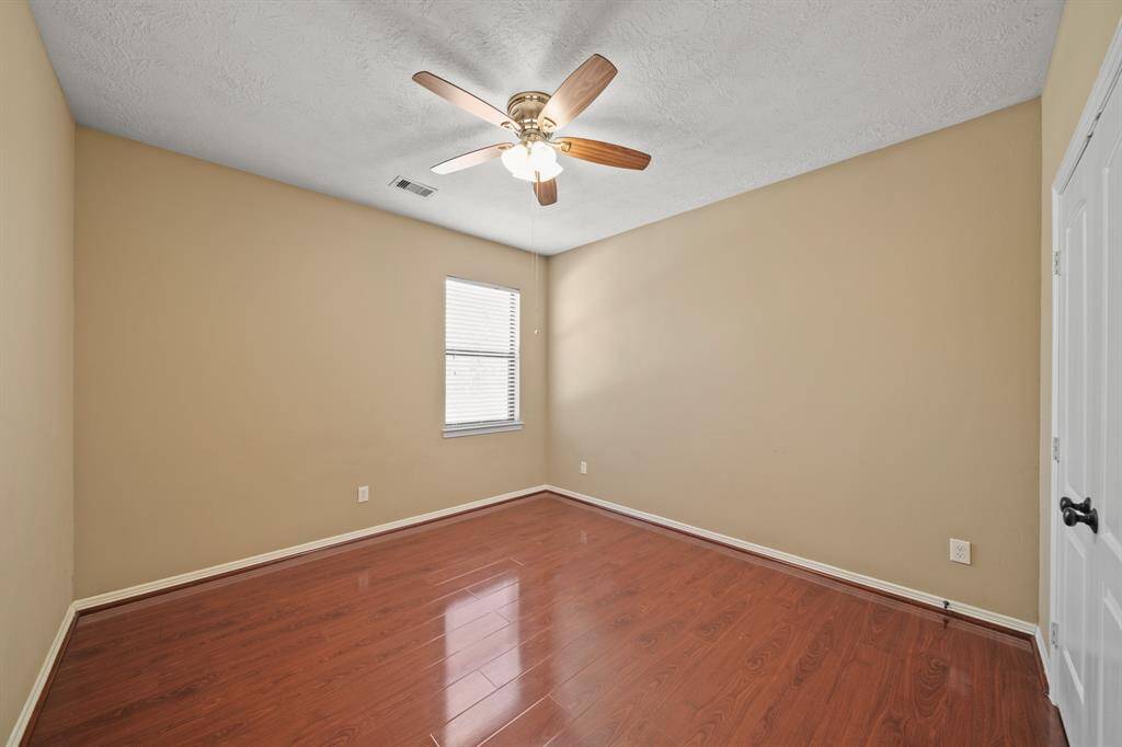 Another Secondary Bedroom with ceiling fan, wood flooring and window