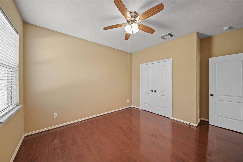 Another view of the spacious secondary bedroom to retreat to with closet space and ceiling fan/ lighting