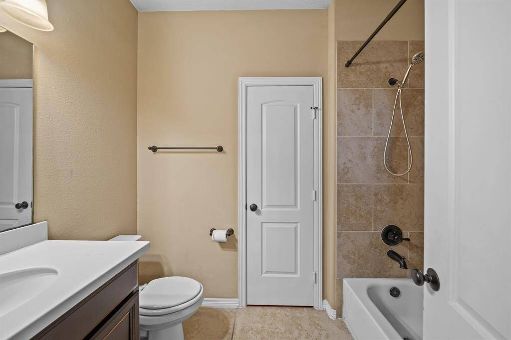Full Bathroom with sink, tub/shower with tile surround and privacy for guests if utilizing En Suite