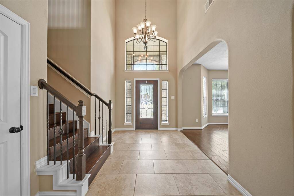 Front entry with soaring ceilings, terrific tile flooring and elegance exuding from the moment of entry