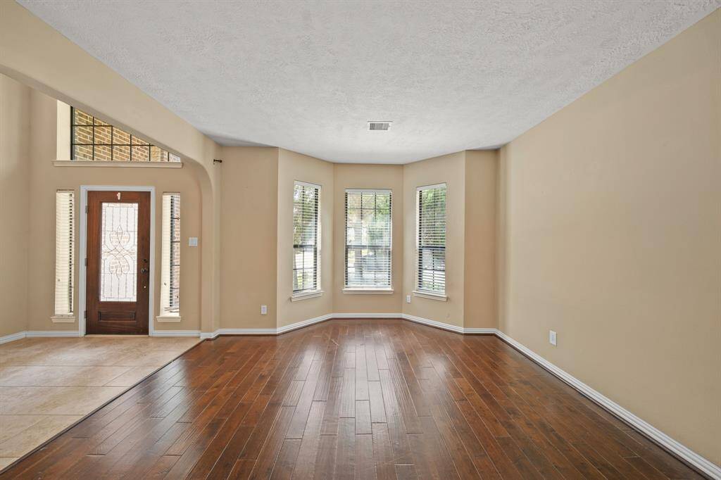 Family Room sits to the left of entry with space for gathering together or an additional entertaining space when hosting