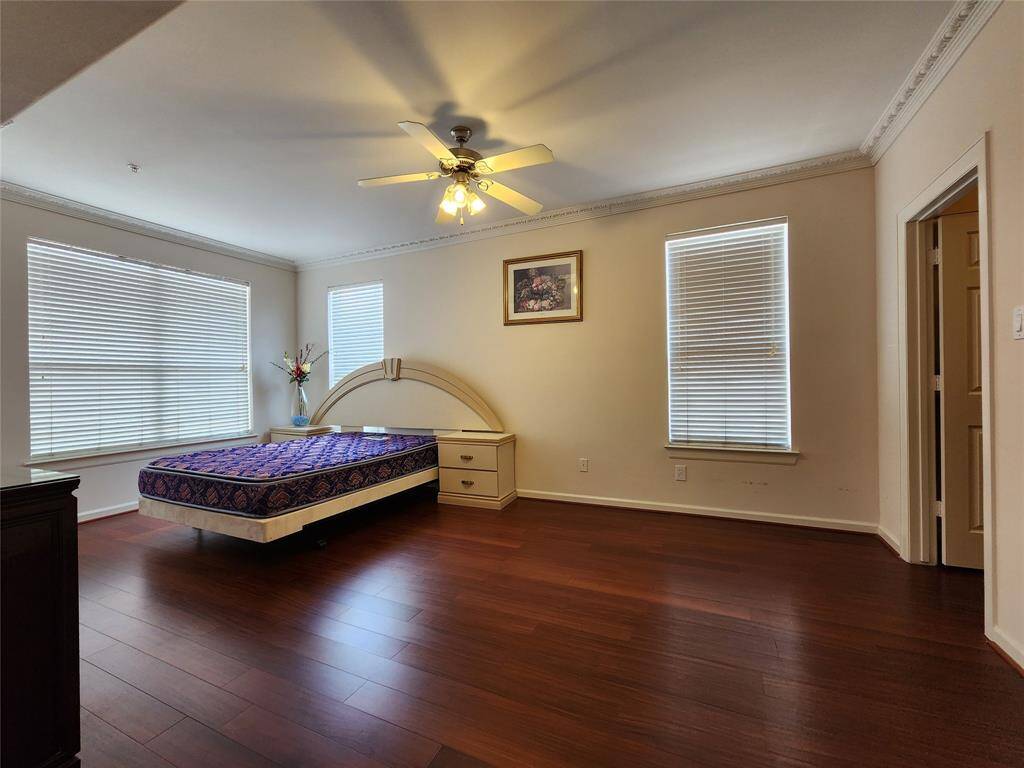 Primary suite is very spacious, with ceiling fan and wood floor, walk in closet.