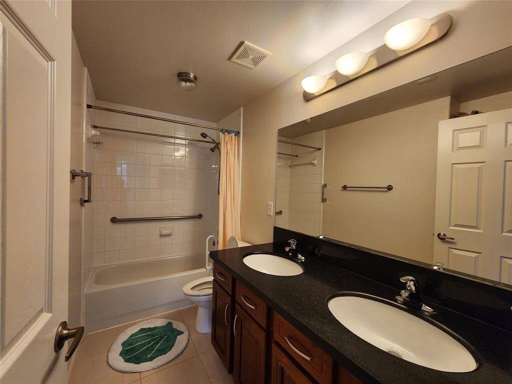 Primary bath room with double sinks, tub/shower.
